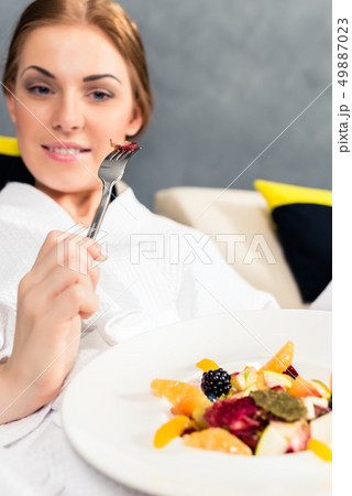 Smiling woman eating healthy food Smiling woman eating healthy food 49887023