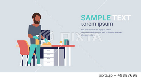 man cleaning computer table with duster african american guy wiping workplace desk housework concept 49887698