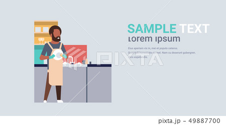 young man washing dishes african american guy wiping plates on kitchen doing housework dishwashing young man washing dishes african american guy wiping plates on kitchen doing housework dishwashing 49887700