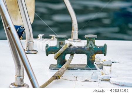 Close up of boat rope tied to nautical cleat hitch on boat 49888193