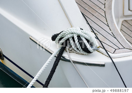 Close up of boat rope tied to nautical cleat hitch on boat 49888197