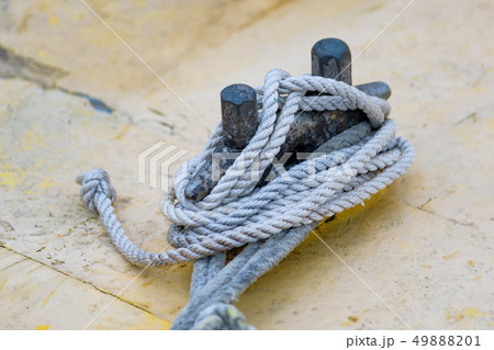 Close up of boat rope tied to nautical cleat hitch on boat 49888201