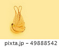 Reusable bag with bananas on yellow background. Zero waste and plastic free shopping concept. 49888542