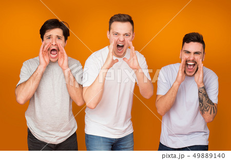 Men screaming loudly over orange studio background 49889140