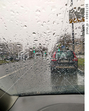 Raindrops on the windshield. View from inside the car Raindrops on the windshield. View from inside the car 49891156