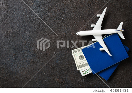Airplane model, two passports and money on a dark Airplane model, two passports and money on a dark 49891451