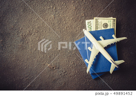 Miniature airplane, two passports and money on a 49891452