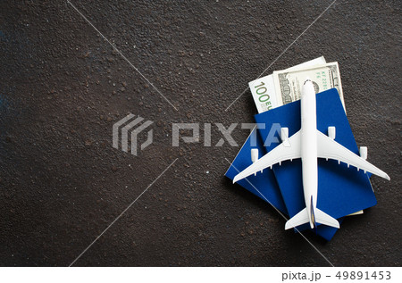 Airplane model, two passports and money on a dark Airplane model, two passports and money on a dark 49891453