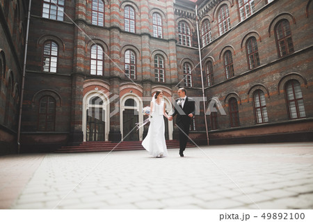 Gorgeous wedding couple walking in the old city of Lviv 49892100