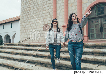 girl tourists walking downstairs exploring view girl tourists walking downstairs exploring view 49896116