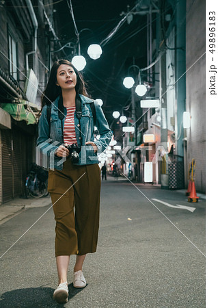 beautiful girl walking in night street in osaka beautiful girl walking in night street in osaka 49896183