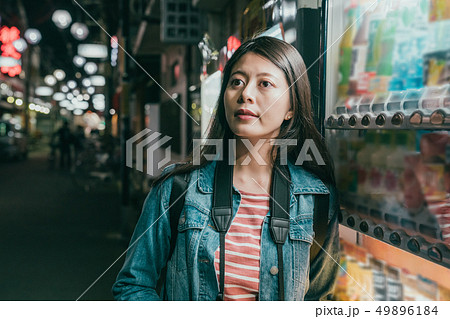 asian woman stand next to vendor machine 49896184