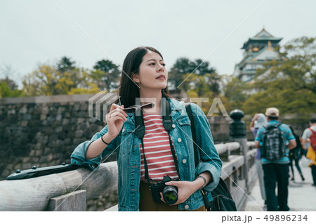 photographer leaning on bridge fence relaxing photographer leaning on bridge fence relaxing 49896234