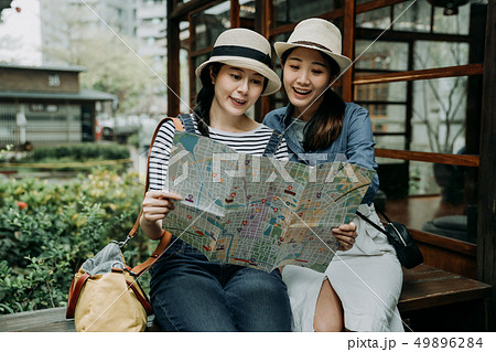 girls look at map searching destination in garden 49896284