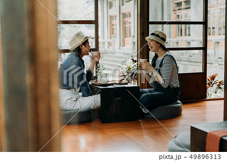 friends sit wooden house holding matcha tea bowl 49896313