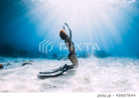 Freediver young woman with fins posing 49897644