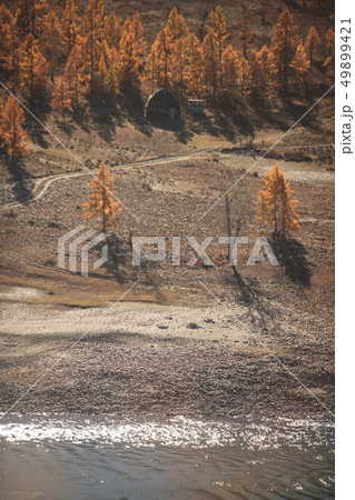 Mongolian yurt and ruined house near the large mountain and river. Autumn landscape. Altai mountains Mongolian yurt and ruined house near the large mountain and river. Autumn landscape. Altai mountains 49899421