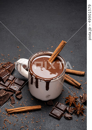 Cup of hot chocolate and pieces of chocolat on dark concrete background Cup of hot chocolate and pieces of chocolat on dark concrete background 49901579