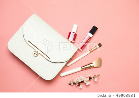 Makeup bag with cosmetics isolated on living coral 49903931