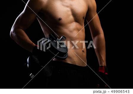 Closeup of a strength fitness body with dumbbell. Closeup of a strength fitness body with dumbbell. 49906543
