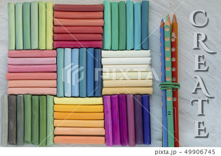 Rainbow pastel crayons and bunch of pencils, 49906745