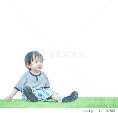 Closeup happy kid sit on grass floor in the garden Closeup happy kid sit on grass floor in the garden 49906905