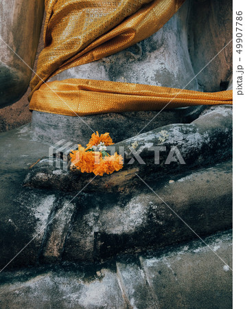 Yellow flower in hand of Ruined grunge buddha Yellow flower in hand of Ruined grunge buddha 49907786