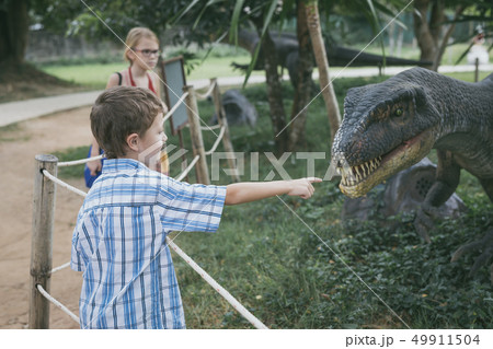 little boy playing in the adventure dino park. little boy playing in the adventure dino park. 49911504
