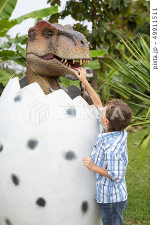 little boy playing in the adventure dino park. little boy playing in the adventure dino park. 49911511