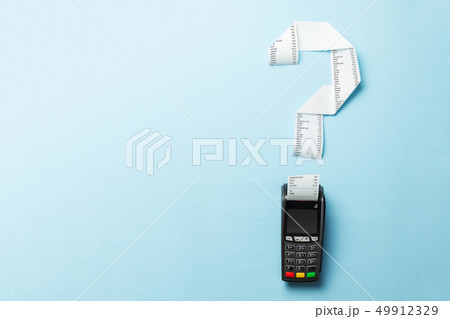 Terminal cash register machine POS for payments and long roll paper cash tape in shape of a question 49912329