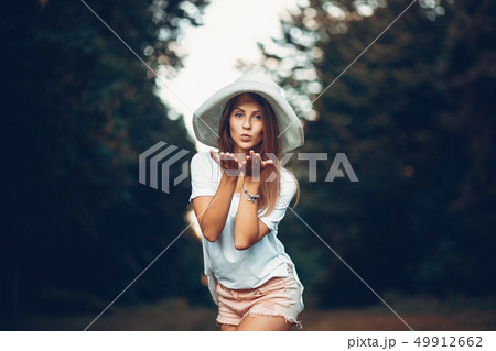 Yound and pretty girl in a summer park Yound and pretty girl in a summer park 49912662