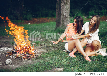 Two pretty girls in a summer park Two pretty girls in a summer park 49912714