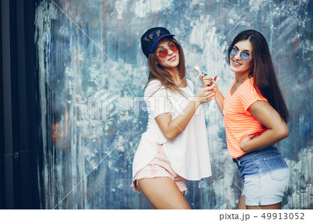 Two pretty girls in a summer park Two pretty girls in a summer park 49913052