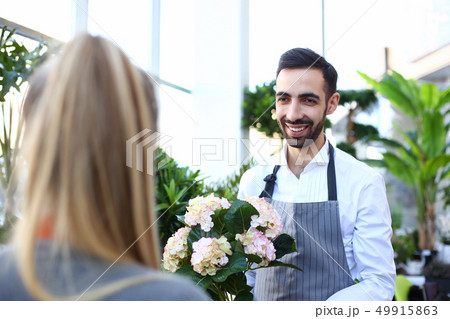 Smiling italian man seller of flowers stretches 49915863