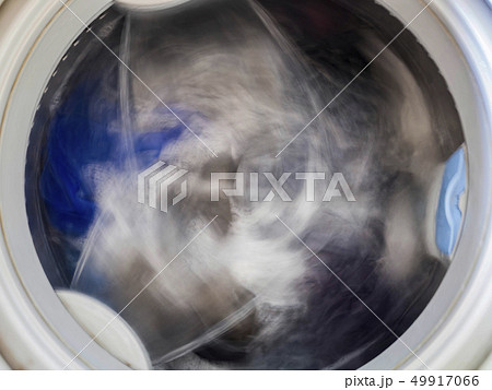 Top loading washing machine washes laundry. Top loading washing machine washes laundry. 49917066