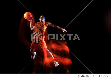 Young basketball player against dark background 49917995