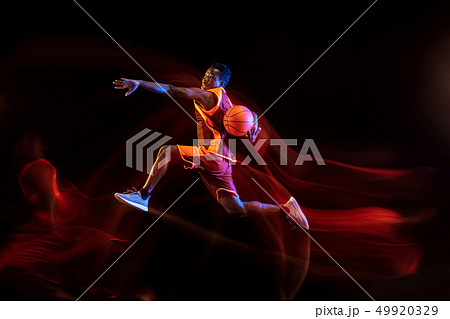 Young basketball player against dark background Young basketball player against dark background 49920329