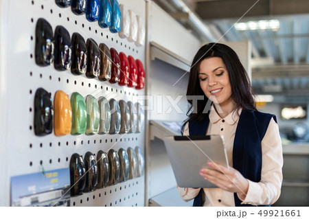 Professional salesperson help to chose color for a car in dealership center 49921661