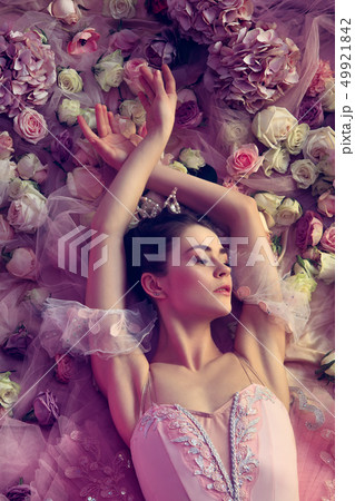 Young woman in pink ballet tutu surrounded by flowers Young woman in pink ballet tutu surrounded by flowers 49921842