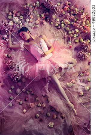 Young woman in pink ballet tutu surrounded by flowers Young woman in pink ballet tutu surrounded by flowers 49922003