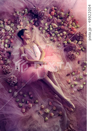 Young woman in pink ballet tutu surrounded by flowers Young woman in pink ballet tutu surrounded by flowers 49922004