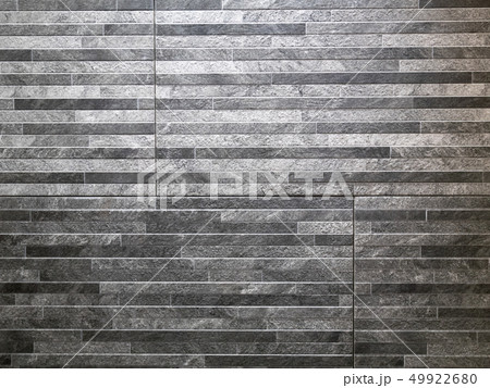 abstract pattern wall made of grey granite stones 49922680