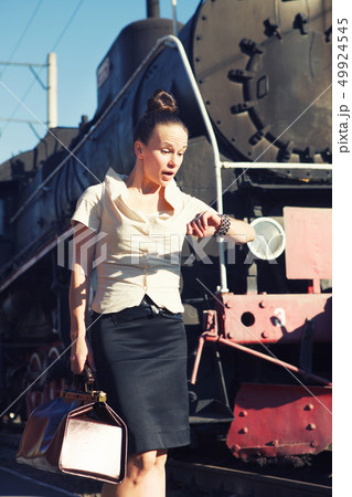 Woman on the platform near the retro train 49924545