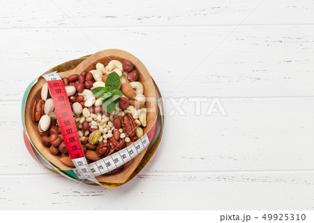 Various nuts selection on wooden table 49925310