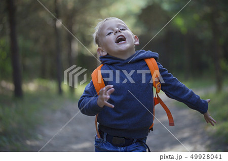 A happy little boy runs along a forest path A happy little boy runs along a forest path 49928041