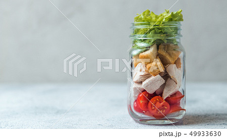 Caesar salad in glass mason jar, copy space Caesar salad in glass mason jar, copy space 49933630