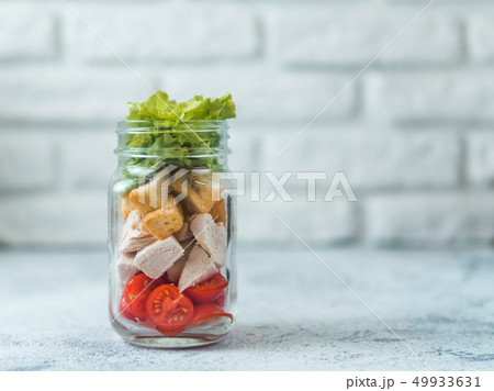 Caesar salad in glass mason jar, copy space Caesar salad in glass mason jar, copy space 49933631
