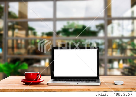 Laptop with blank screen on table. Laptop with blank screen on table. 49935357