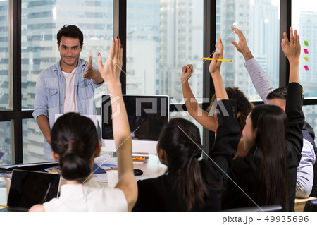 Business people raising there hand up at office Business people raising there hand up at office 49935696