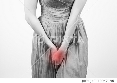 Close up of a woman with hands holding her crotch 49942196